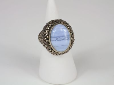 a silver ring with a blue stone in the center