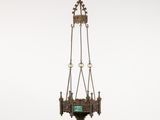an antique brass hanging lamp with a green glass shade