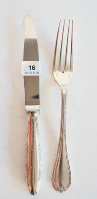 deux fourchettes et un couteau sur une table blanche