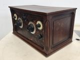 an old fashioned radio sitting on top of a white table