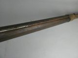 an old baseball bat hanging on a wall