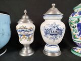 several different types of vases are lined up on a black surface