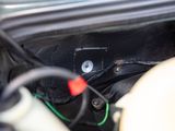 a close up of a car ' s dashboard with wires and wires attached to it