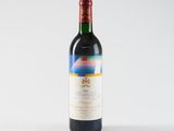a bottle of wine sitting on top of a white table