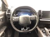 the interior of a car with a steering wheel and dashboard controls