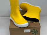 pair of yellow rain boots sitting on top of a cardboard box