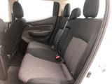 the back seats of a car with a remote control in the passenger seat