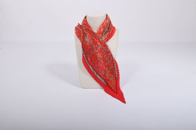 a red scarf on a white mannequin with a white background