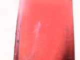 un livre rouge posé sur une surface blanche