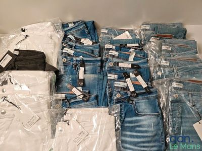 a pile of jeans and other clothing on a table