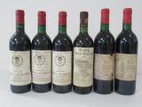 six bottles of wine are lined up in a row on a table
