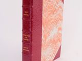 a red book that is sitting on a white surface