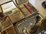 a silver tray with silverware and silverware in it