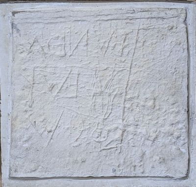 a close up of a stone block with writing on it