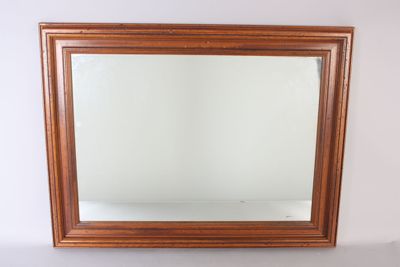 an image of a mirror on a white wall with a wooden frame