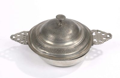 a silver pot with a lid on a white surface
