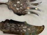 two forks and a knife sitting on a table