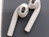 two white airpods sitting on top of a table next to each other