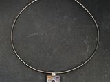 a close up of a necklace on a black surface