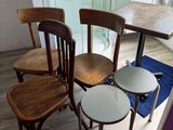 four chairs and a table in a small room
