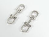 pair of silver metal buckles on a white surface