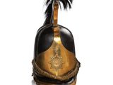 an old helmet with a feather on top of it on a white surface