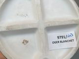 a person holding a white plate with a sticker on it