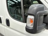 an image of a side view mirror of a white van