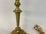 an image of a gold colored lamp with a chain around it