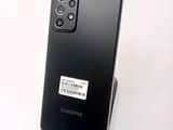 a close up of the back of a black samsung galaxy s20 with a barcode sticker on it