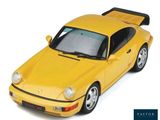 a yellow toy car that is sitting on a white surface