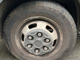 a black truck with a flat tire on the street
