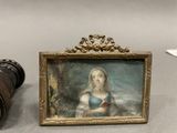 a picture of a woman in a blue dress next to a pair of binoculars