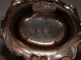 a silver bowl with a label on it on a table