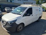 the white van is parked in the parking lot outside of the building