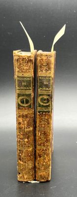 two old books that are sitting on a table
