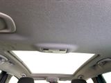 the interior of a car with the sun shining through the roof