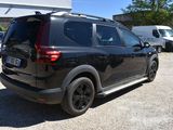a black suv that is parked in a parking lot