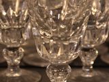 several empty wine glasses are lined up on a table