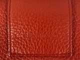 a close up view of a red leather wallet