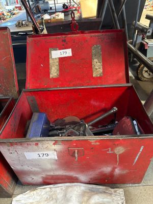 a red box with tools in it sitting on the floor