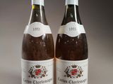 two bottles of wine sitting next to each other on a table