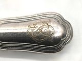 a silver spoon that has a design on it
