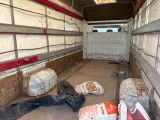 many bags of food in the back of a truck