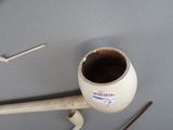 a picture of a pipe with a sticker on it next to a pair of scissors