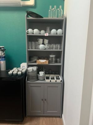 a small kitchen with a black refrigerator and a black refrigerator freezer