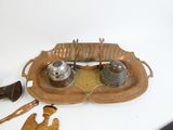 a wooden tray that has a pair of salt and pepper shakers on it