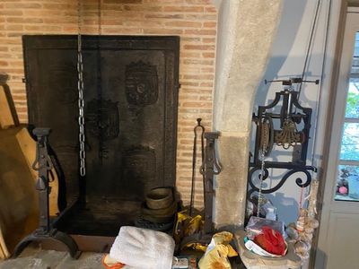 a fire place in the middle of a room with a bunch of things on the table