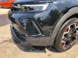 a close up of the front end of a black suv