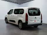 the white van is parked in the large room of the building